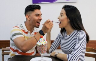 Men and women eating a dessert ice-cream on a date